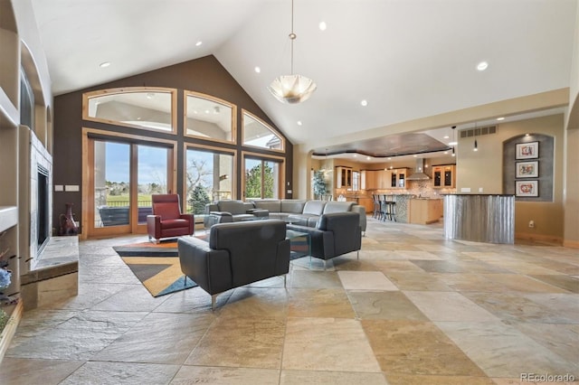 living room featuring high vaulted ceiling