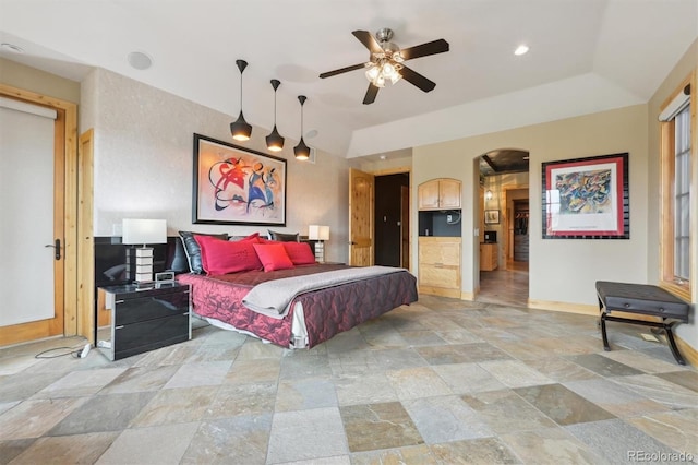 bedroom with ceiling fan and a raised ceiling