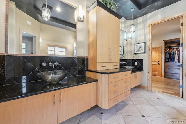 bathroom featuring decorative backsplash and vanity