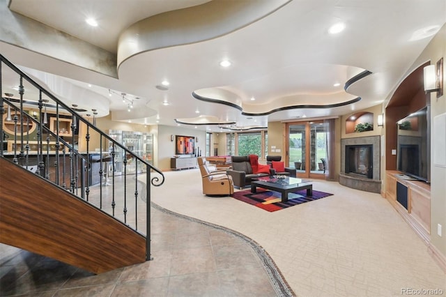 living room featuring light tile patterned flooring and a tile fireplace