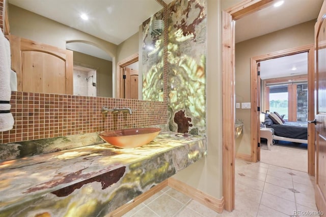 bathroom featuring backsplash, tile patterned floors, and vanity