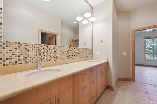 bathroom featuring tile patterned flooring, vanity, and backsplash