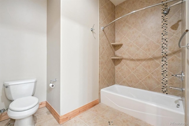 bathroom with tile patterned floors, toilet, and tiled shower / bath