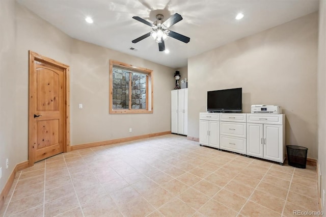 unfurnished living room with ceiling fan and light tile patterned floors