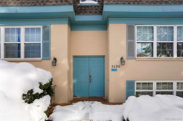 view of snow covered property entrance