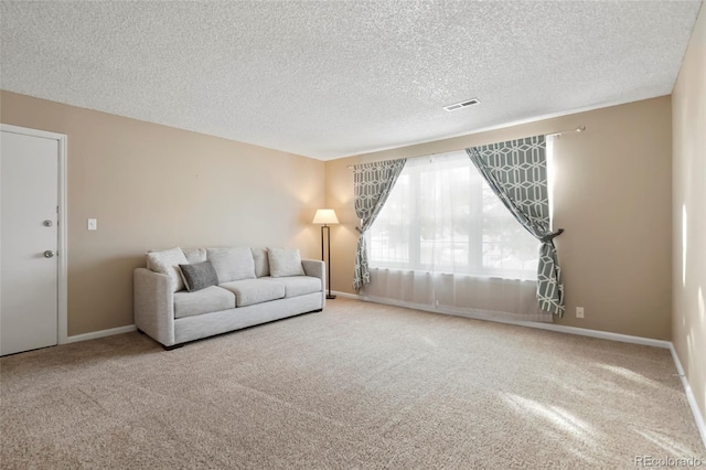 unfurnished living room featuring a textured ceiling and carpet floors