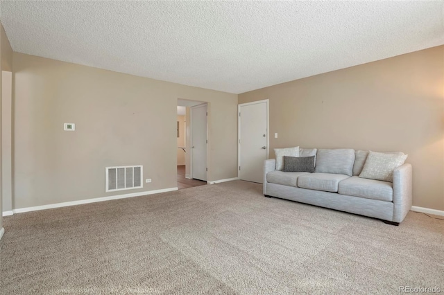 living room featuring a textured ceiling and light carpet