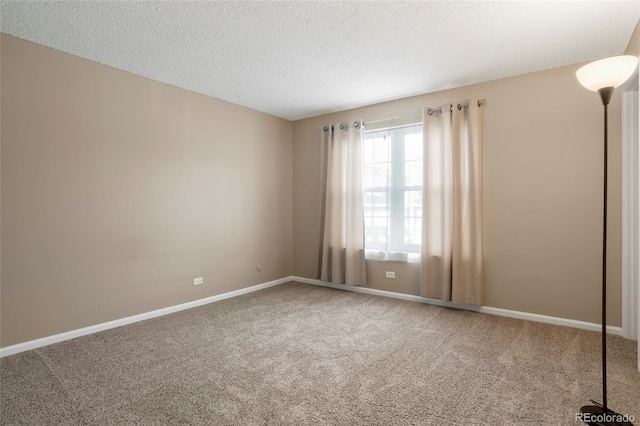 carpeted spare room with a textured ceiling