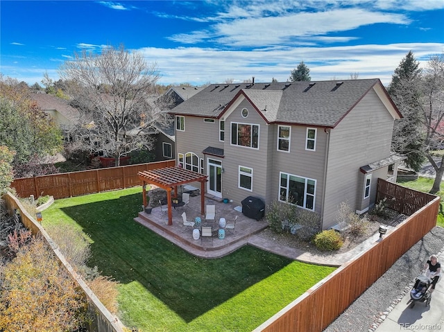 back of house with a lawn, a pergola, and a patio