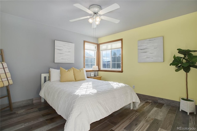 bedroom with ceiling fan and dark hardwood / wood-style floors