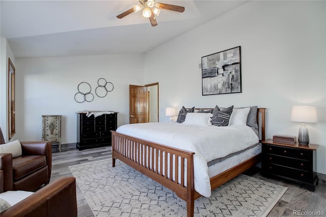 bedroom with hardwood / wood-style floors, ceiling fan, and lofted ceiling