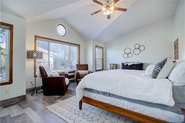 bedroom featuring light hardwood / wood-style floors, ceiling fan, and lofted ceiling