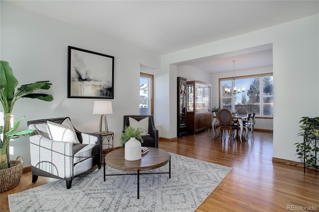 living room with a chandelier and hardwood / wood-style flooring