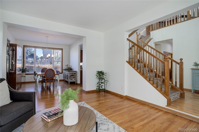 living room featuring hardwood / wood-style floors and a notable chandelier