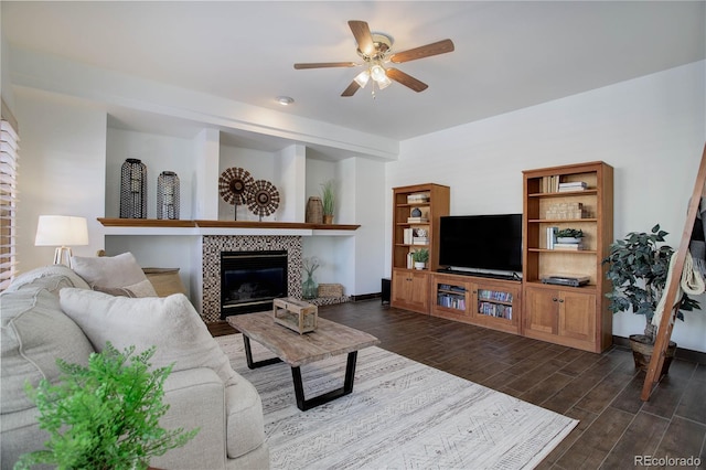 living room with ceiling fan and a fireplace