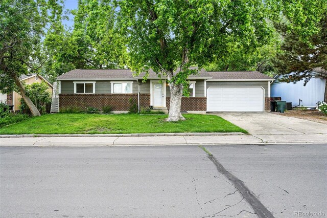 11625 Bellaire Way, Thornton, CO 80233 - view of front of house featuring brick siding, a garage, driveway, and a front lawn