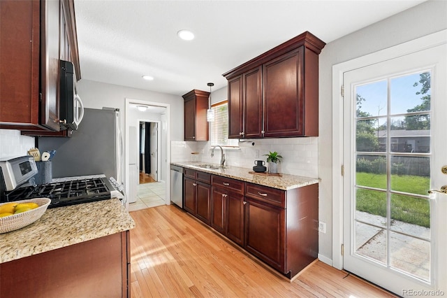 11625 Bellaire Way, Thornton, CO 80233 - kitchen with tasteful backsplash, appliances with stainless steel finishes, light wood-style floors, light stone counters, and recessed lighting