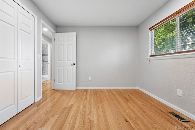 11625 Bellaire Way, Thornton, CO 80233 - unfurnished bedroom featuring light wood finished floors, baseboards, and a closet
