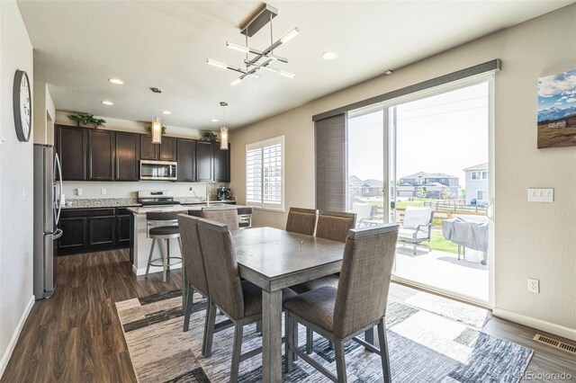 6954 E 117th Ave, Thornton, CO 80233 - dining space featuring dark wood-style floors, baseboards, and recessed lighting