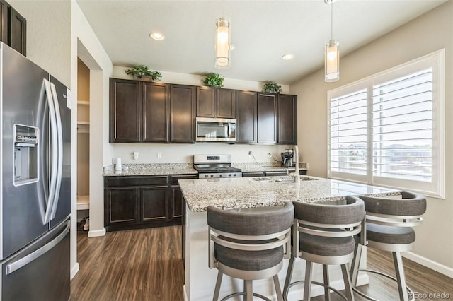 6954 E 117th Ave, Thornton, CO 80233 - kitchen featuring appliances with stainless steel finishes, dark wood-type flooring, a sink, baseboards, and dark brown cabinetry