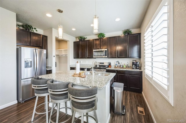 6954 E 117th Ave, Thornton, CO 80233 - kitchen featuring appliances with stainless steel finishes, dark wood-type flooring, dark brown cabinets, and recessed lighting