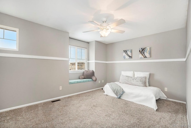 10247 Telluride Way, Commerce City, CO 80022 - bedroom with multiple windows, carpet, and ceiling fan