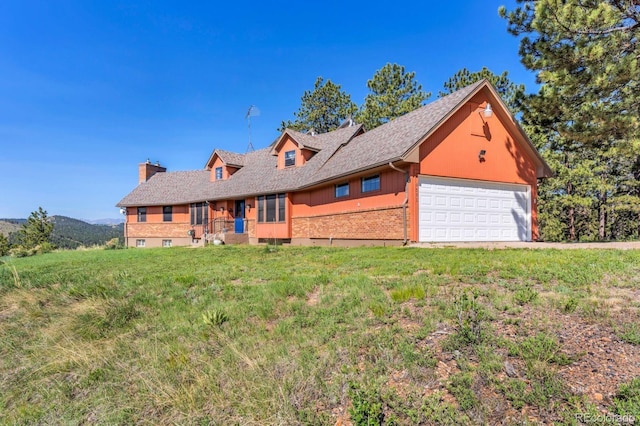 9591 State Highway 96, Westcliffe, CO 81252 - view of front facade with brick siding, a front yard, a chimney, and roof with shingles