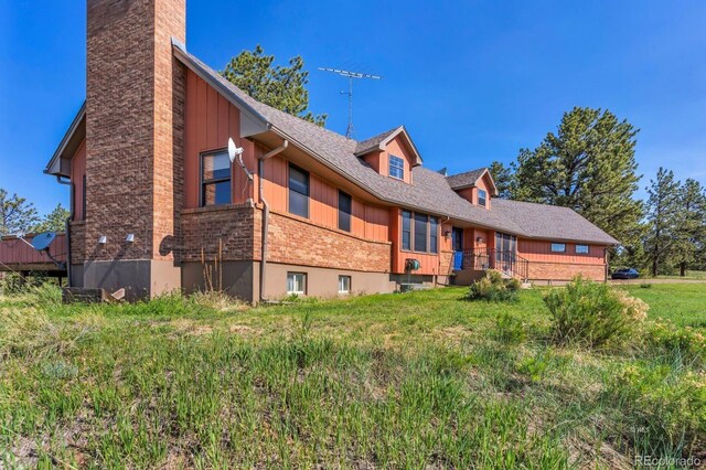 9591 State Highway 96, Westcliffe, CO 81252 - rear view of property with brick siding, a chimney, and roof with shingles