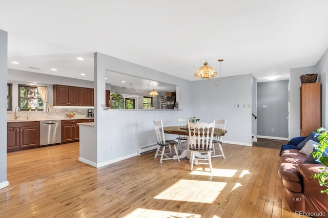 9591 State Highway 96, Westcliffe, CO 81252 - dining room with light wood finished floors, a chandelier, recessed lighting, and a baseboard heating unit