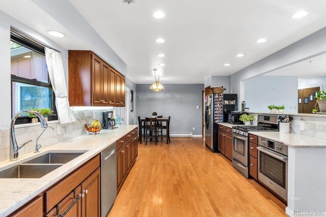 9591 State Highway 96, Westcliffe, CO 81252 - kitchen with stainless steel appliances, backsplash, recessed lighting, light stone countertops, and brown cabinets