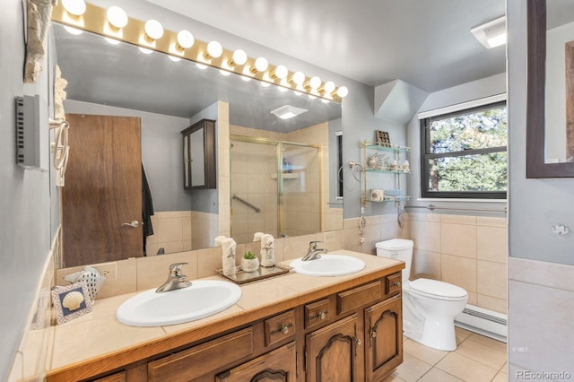 9591 State Highway 96, Westcliffe, CO 81252 - full bathroom featuring tile patterned floors, a shower stall, double vanity, tile walls, and baseboard heating
