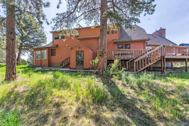 9591 State Highway 96, Westcliffe, CO 81252 - back of house with a wooden deck, a chimney, roof with shingles, and stairs