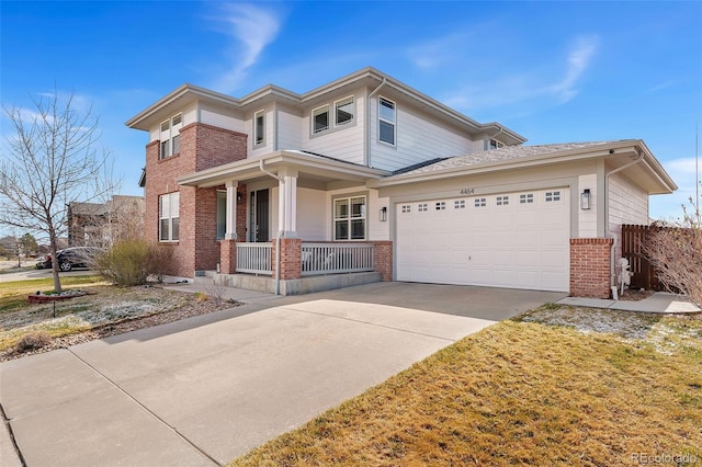 4464 E 139th Ave, Thornton, CO 80602 - view of front of house with brick siding, covered porch, a garage, and driveway