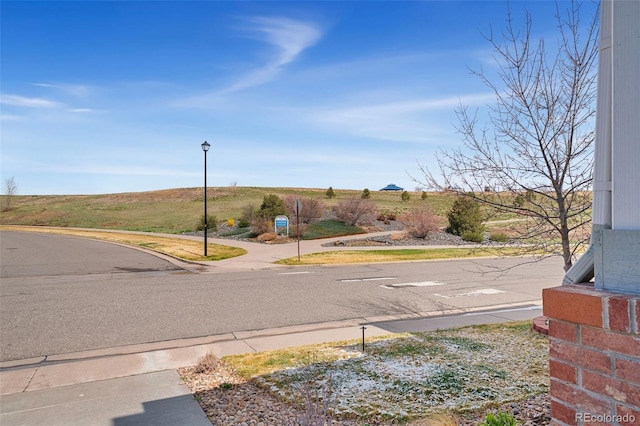 4464 E 139th Ave, Thornton, CO 80602 - view of asphalt street featuring street lights, sidewalks, and curbs