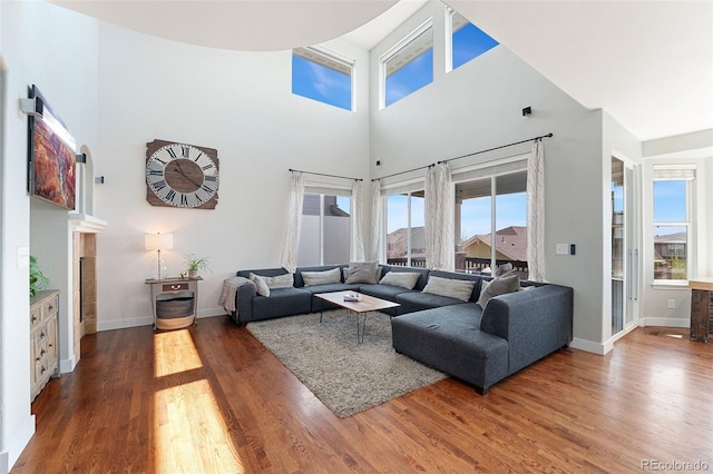 4464 E 139th Ave, Thornton, CO 80602 - living room with a towering ceiling, wood finished floors, and baseboards