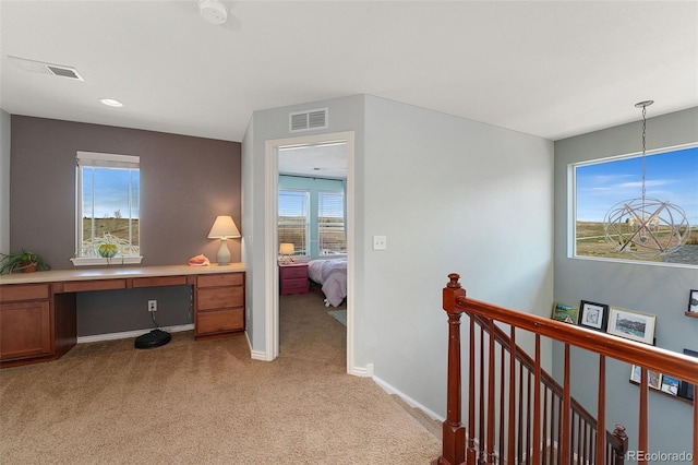 4464 E 139th Ave, Thornton, CO 80602 - corridor featuring an upstairs landing, light colored carpet, a desk, a chandelier, and baseboards