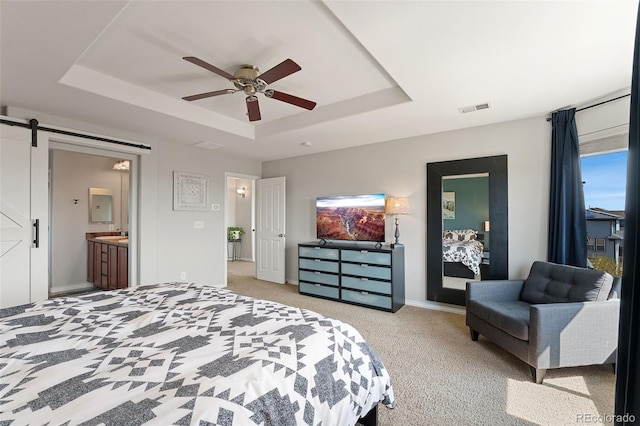 4464 E 139th Ave, Thornton, CO 80602 - bedroom featuring a tray ceiling, a barn door, light carpet, a ceiling fan, and ensuite bathroom