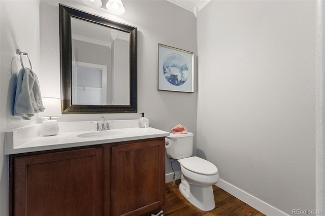 4464 E 139th Ave, Thornton, CO 80602 - half bathroom featuring crown molding, toilet, vanity, wood finished floors, and baseboards