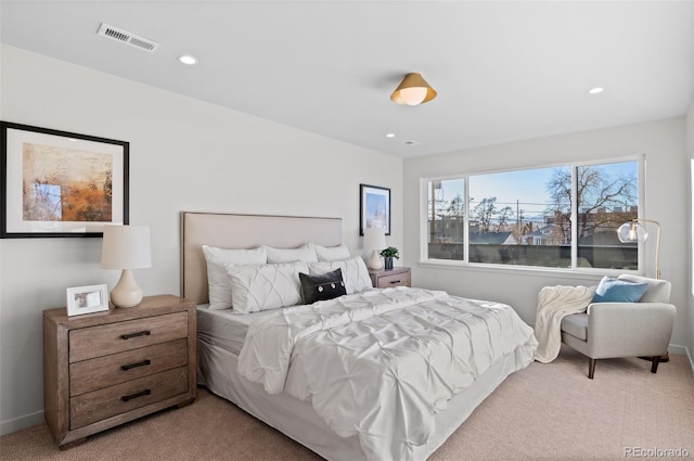 bedroom featuring light carpet