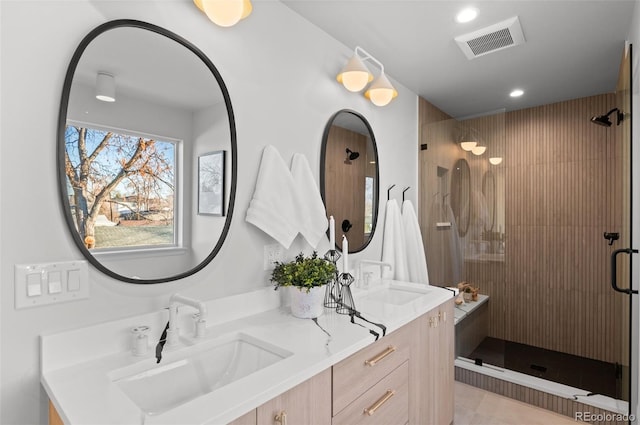 bathroom featuring an enclosed shower and vanity