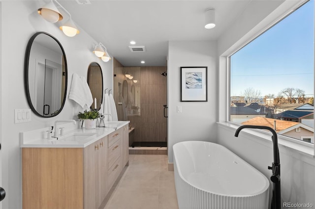 bathroom with independent shower and bath, vanity, tile patterned floors, and plenty of natural light