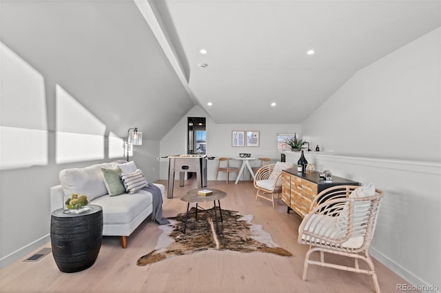 sitting room with lofted ceiling and light hardwood / wood-style flooring