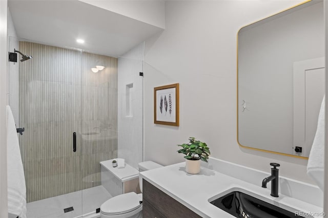 bathroom with walk in shower, vanity, and toilet