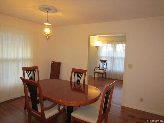 dining room with dark wood-type flooring