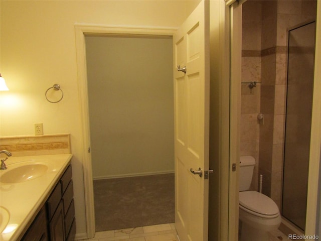 bathroom with vanity, toilet, and a shower with shower door