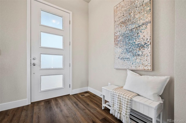 entrance foyer featuring visible vents, baseboards, and dark wood-type flooring