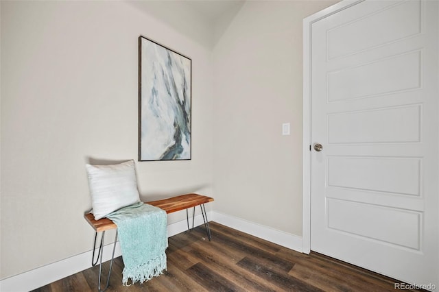 living area with baseboards and wood finished floors