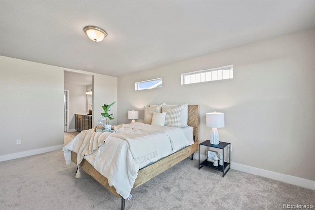 bedroom featuring baseboards, carpet flooring, and ensuite bathroom