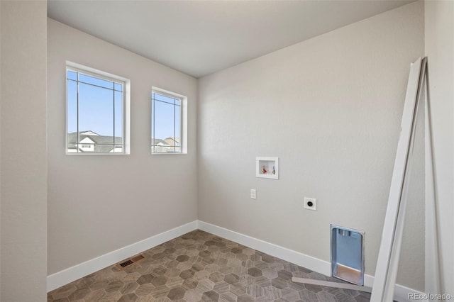 clothes washing area with laundry area, visible vents, baseboards, hookup for a washing machine, and electric dryer hookup