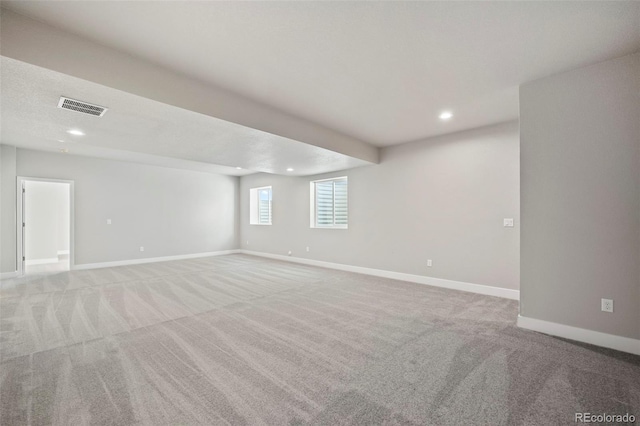 empty room featuring recessed lighting, baseboards, visible vents, and light colored carpet